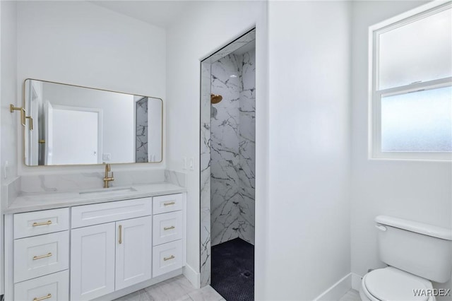 full bathroom featuring marble finish floor, toilet, vanity, and a marble finish shower