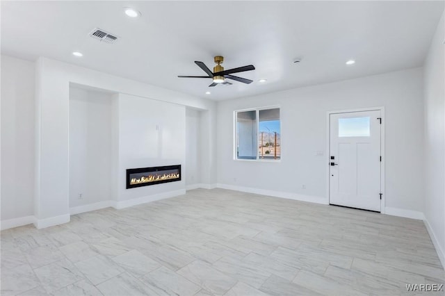 unfurnished living room featuring ceiling fan, a glass covered fireplace, visible vents, and recessed lighting