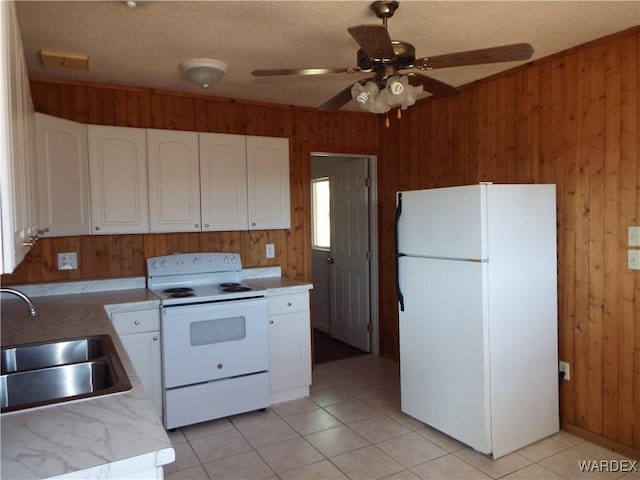 17516 N Ladera Dr, Dolan Springs, AZ 86441 - kitchen with white appliances, light countertops, wood walls, and a sink