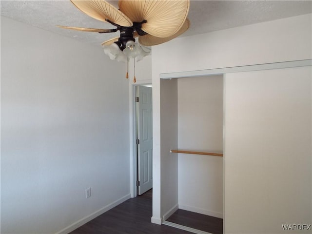17516 N Ladera Dr, Dolan Springs, AZ 86441 - unfurnished bedroom with a closet, baseboards, dark wood-style floors, and a ceiling fan