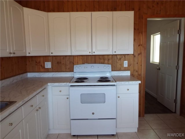 17516 N Ladera Dr, Dolan Springs, AZ 86441 - kitchen featuring light tile patterned floors, white cabinets, and electric stove