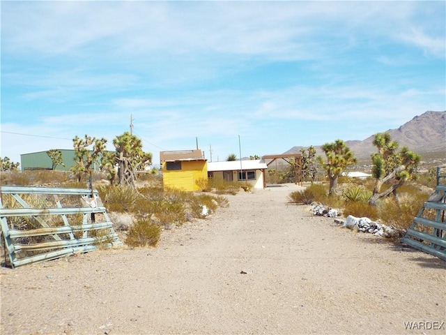 17516 N Ladera Dr, Dolan Springs, AZ 86441 - view of street with a gated entry, a mountain view, and driveway