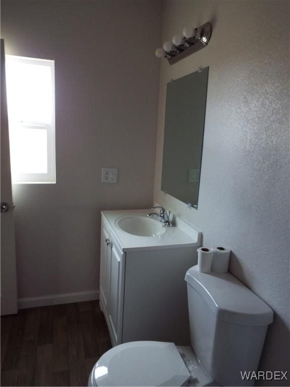 17516 N Ladera Dr, Dolan Springs, AZ 86441 - bathroom featuring baseboards, toilet, wood finished floors, and vanity
