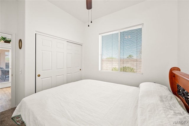 bedroom with a ceiling fan, a closet, and wood finished floors