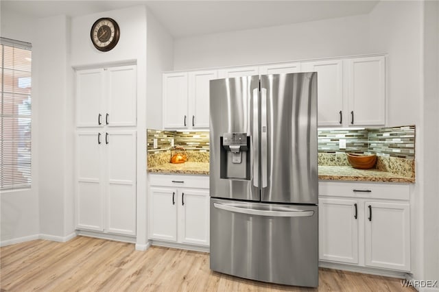 kitchen featuring white cabinetry and stainless steel fridge with ice dispenser