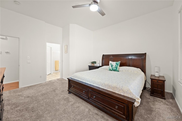 bedroom with light carpet, a ceiling fan, and baseboards