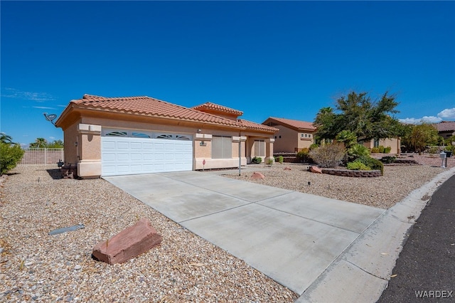 view of front of property featuring a garage, driveway, a tiled roof, and stucco siding