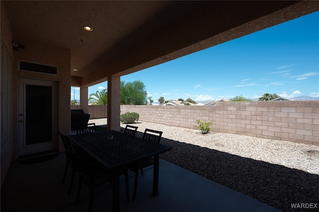 view of patio with a fenced backyard and outdoor dining space