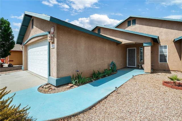 4875 N Famoso Dr, Kingman, AZ 86409 - view of front of home with an attached garage, stucco siding, and driveway