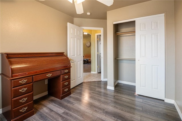 4875 N Famoso Dr, Kingman, AZ 86409 - unfurnished office with dark wood finished floors, a ceiling fan, and baseboards