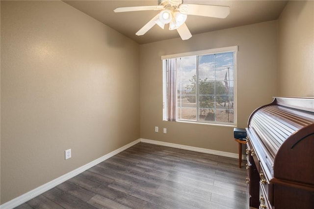 4875 N Famoso Dr, Kingman, AZ 86409 - unfurnished bedroom featuring dark wood finished floors, baseboards, and ceiling fan