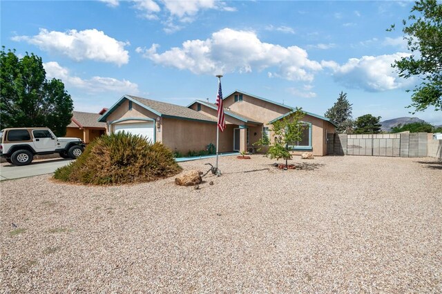 4875 N Famoso Dr, Kingman, AZ 86409 - ranch-style house with fence, stucco siding, and an attached garage
