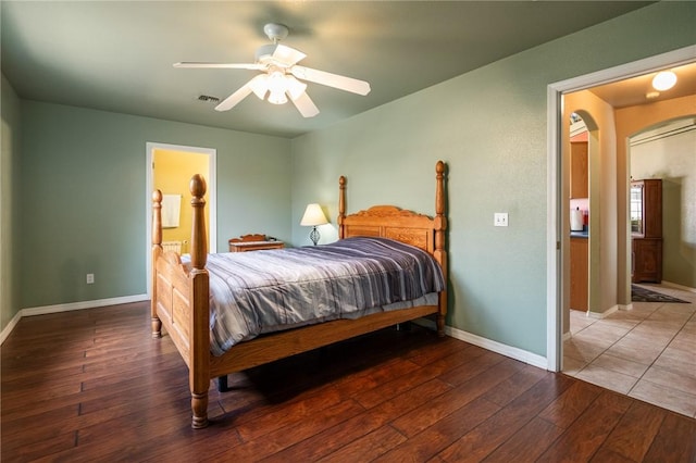 4875 N Famoso Dr, Kingman, AZ 86409 - bedroom with hardwood / wood-style flooring, baseboards, arched walkways, and a ceiling fan