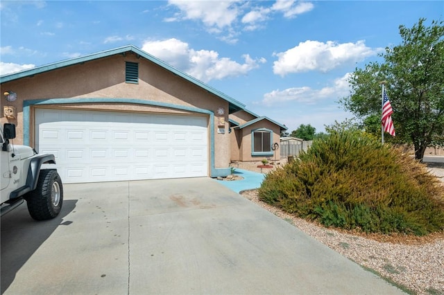 4875 N Famoso Dr, Kingman, AZ 86409 - ranch-style house with stucco siding, driveway, and a garage