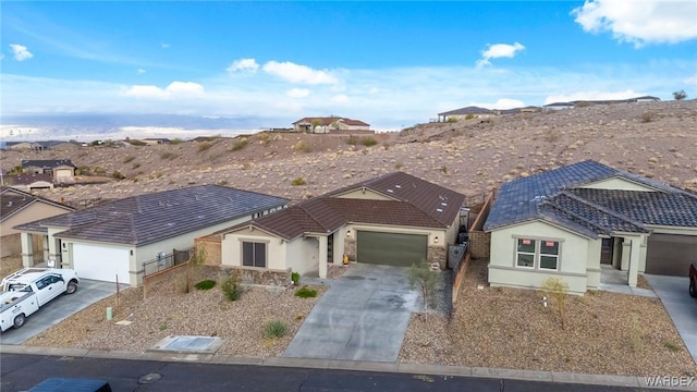 ranch-style home featuring a garage, driveway, and stucco siding