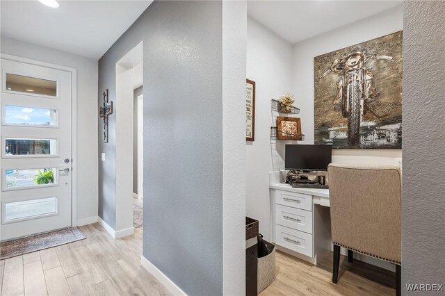 entrance foyer featuring light wood finished floors and baseboards