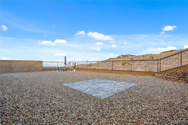 view of yard with a fenced backyard and a patio