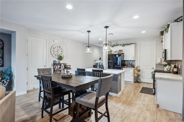 dining room with light wood-type flooring, visible vents, baseboards, and recessed lighting