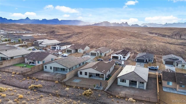 drone / aerial view featuring a residential view and a mountain view