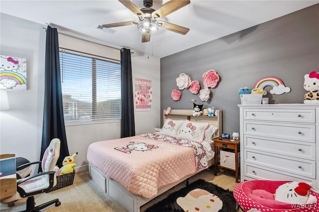 bedroom featuring a ceiling fan, visible vents, and light colored carpet