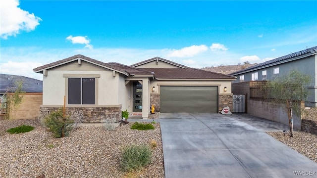 ranch-style home with driveway, stone siding, a garage, and stucco siding