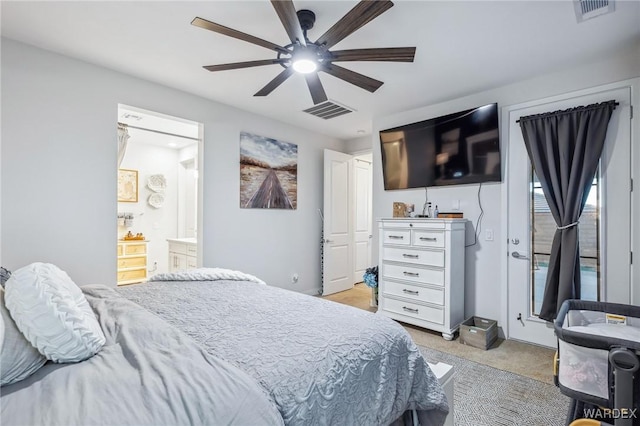 bedroom featuring connected bathroom, light colored carpet, visible vents, and ceiling fan