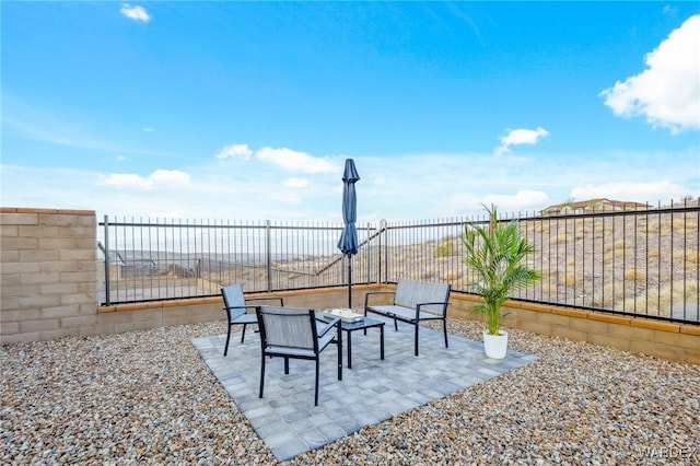 view of patio featuring fence