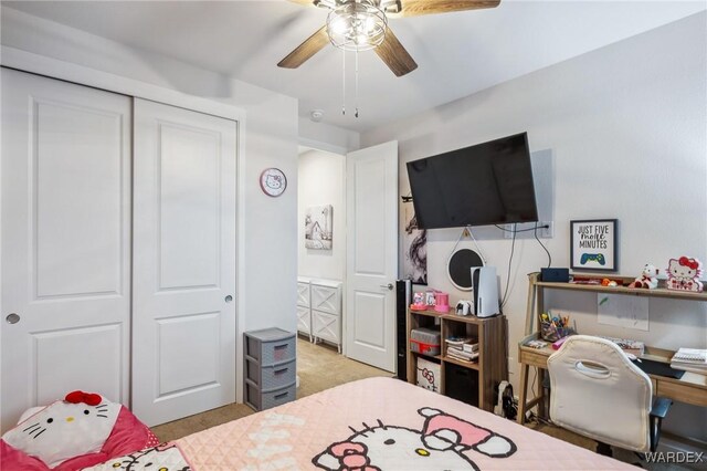 bedroom featuring a closet, a ceiling fan, and light colored carpet