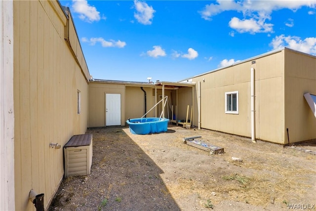 back of house featuring a pool