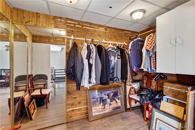 walk in closet featuring a paneled ceiling and wood finished floors