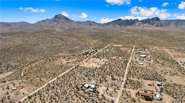 drone / aerial view featuring a mountain view and view of desert