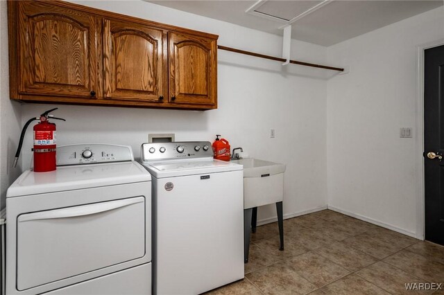 laundry room featuring cabinet space, light tile patterned floors, baseboards, and independent washer and dryer