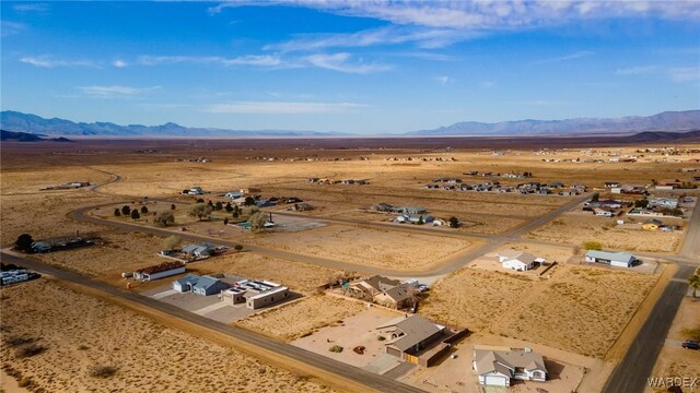 drone / aerial view featuring a mountain view and a desert view