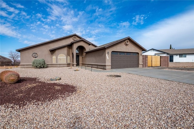 view of front of house with driveway, a garage, and stucco siding