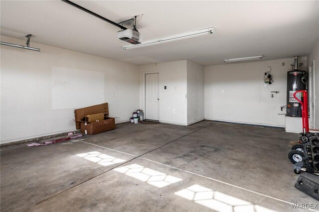 garage featuring a garage door opener and water heater