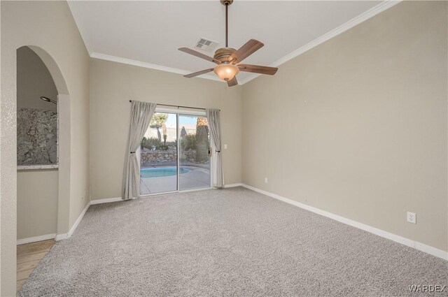 unfurnished room featuring light carpet, baseboards, visible vents, and crown molding