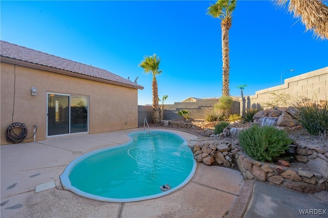 view of swimming pool featuring a fenced backyard, a fenced in pool, and a patio