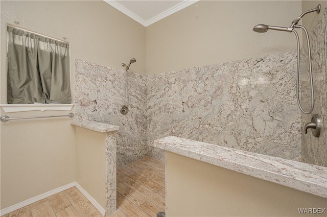 full bathroom with baseboards, ornamental molding, a tile shower, and wood finished floors