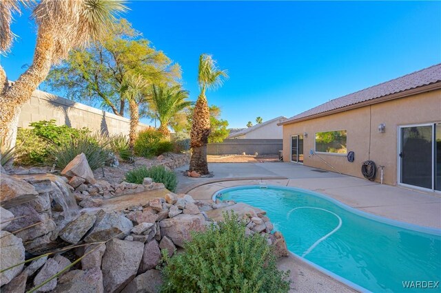 view of swimming pool with a fenced backyard