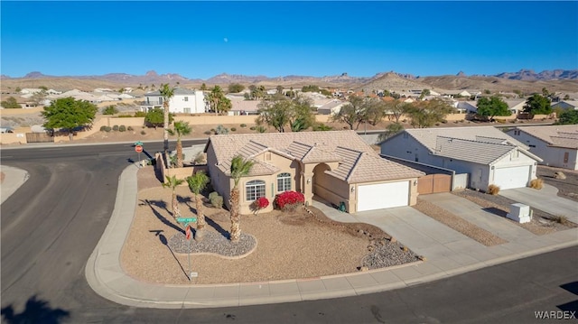 view of front of property with a tile roof, a residential view, and a mountain view