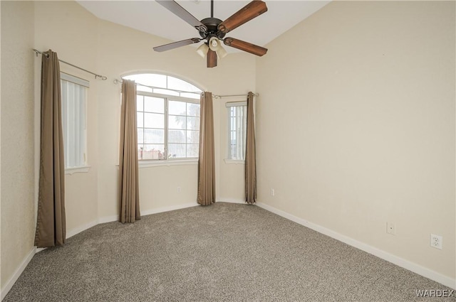 empty room featuring carpet, baseboards, and a ceiling fan