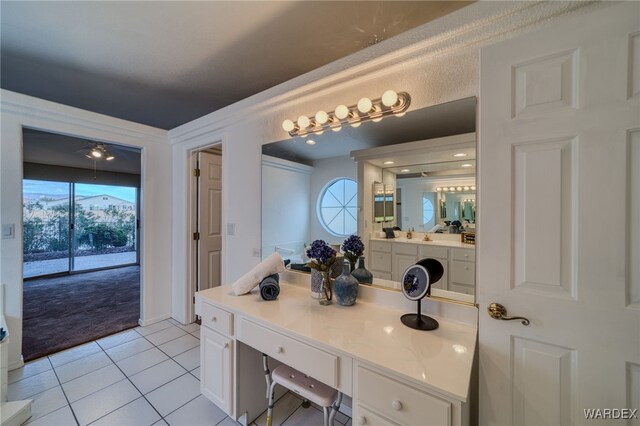 bathroom with tile patterned flooring, vanity, and a wealth of natural light