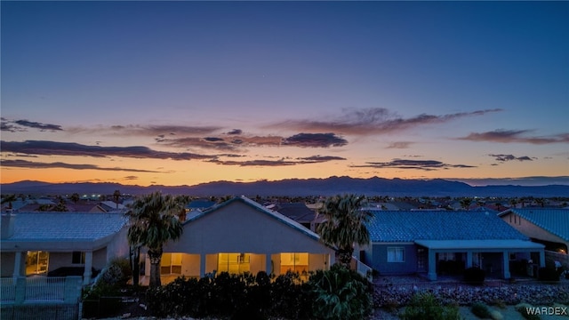 exterior space with a mountain view, stucco siding, and a tile roof