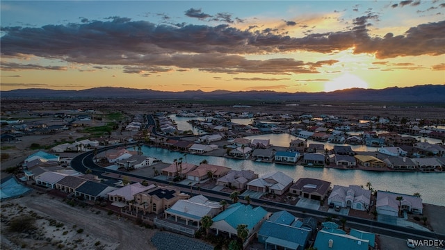 aerial view at dusk with a residential view and a water and mountain view