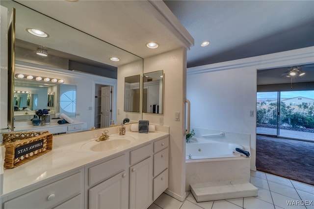 bathroom featuring tile patterned flooring, a jetted tub, recessed lighting, and vanity