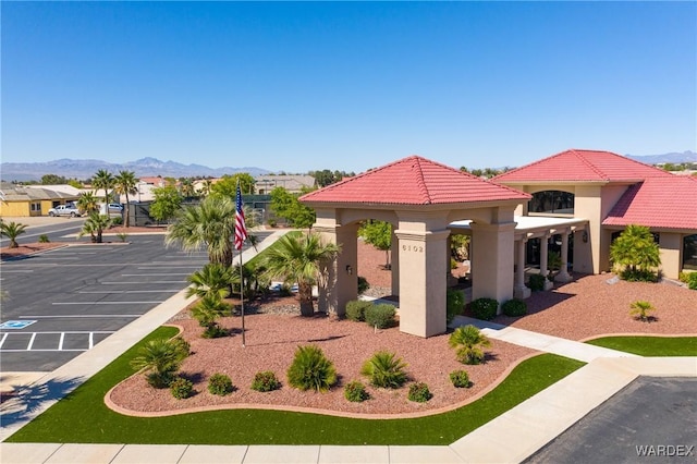 surrounding community featuring a mountain view and uncovered parking