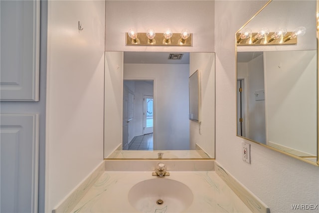 bathroom featuring a sink and visible vents