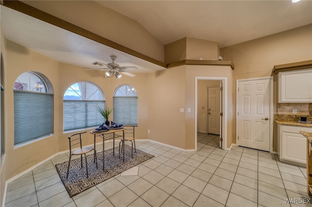 office area with light tile patterned floors, baseboards, lofted ceiling, and ceiling fan