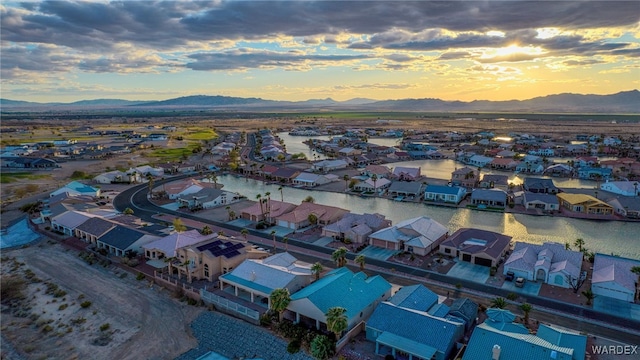 aerial view at dusk with a residential view and a water and mountain view