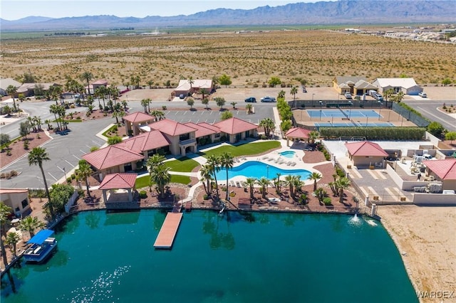 drone / aerial view featuring view of desert, a mountain view, and a residential view